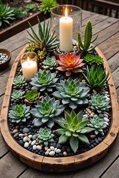 succulents and candles are arranged in a wooden tray on a picnic table