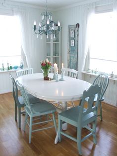 a dining room table with chairs and a chandelier