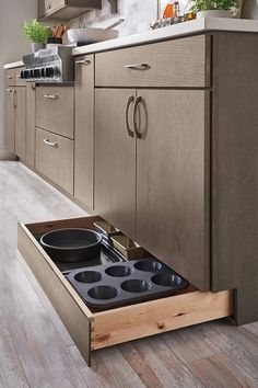 an open drawer in the middle of a kitchen