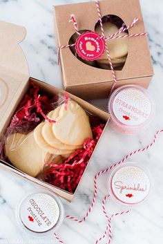 two soaps in a gift box on a marble table with red and white twine