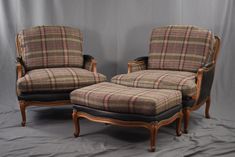 two chairs and a footstool sitting next to each other on a gray background