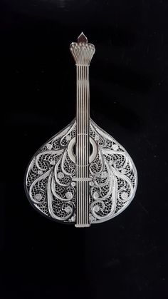 an intricately designed musical instrument is shown on a black background with white trimmings