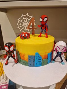 a spiderman themed birthday cake on a table