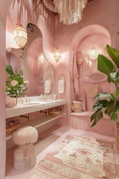 a bathroom decorated in pink and white with lots of lights hanging from the ceiling over the sink