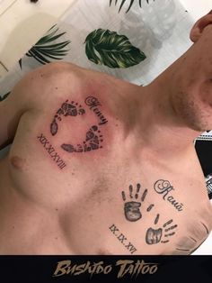 a shirtless man with tattoos on his chest and handprints on his chest