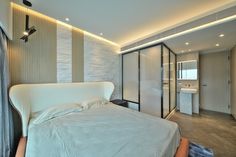 a white bed sitting in a bedroom on top of a hard wood floored floor