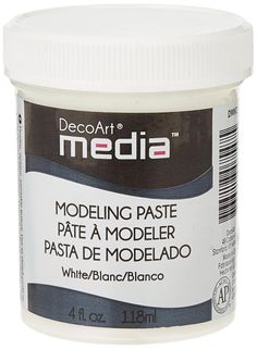 a jar of white modeling paste on a white background