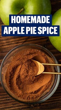 two green apples sitting next to each other on top of a wooden table with spices