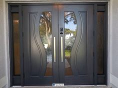 the front door to a house with two glass doors and sidelights on each side