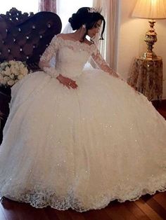 a woman in a wedding dress sitting on a couch