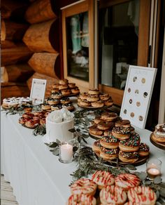 many donuts are lined up on a table