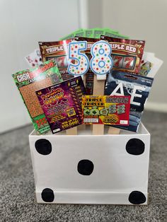 a white box filled with lots of different types of snacks and candys on top of a carpeted floor