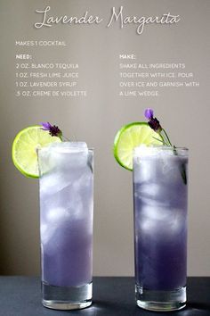 two glasses filled with lavender margaritas and lime wedged in the middle, sitting on a table next to each other