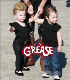 two young children are holding hands with the word grease on it in front of them