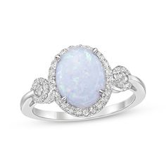 A bold lab-created opal cabochon gives this chic ring a mesmerizing look. Crafted in sterling silver The oval-cut lab-created opal centerpiece is haloed by white lab-created sapphires Loops of white lab-created sapphires decorate the slender shank for added sparkle Oval Cabochon Opal Ring In Fine Jewelry, Oval Cabochon Opal Ring Fine Jewelry, Fine Jewelry Oval Cabochon Opal Ring, Oval Cabochon Opal Ring In White Gold, Oval Cabochon White Gold Opal Ring, Oval White Gold Opal Cabochon Ring, Elegant Oval Opal Ring With Gemstone Accents, Fine Jewelry Oval Opal Ring With Polished Finish, Oval Opal Ring With Polished Finish In Fine Jewelry