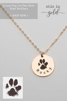 a dog paw necklace with the word rock on it and an image of a cat's paw