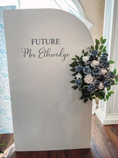 a bouquet of flowers sitting on top of a white sign that says future mrs elheridge