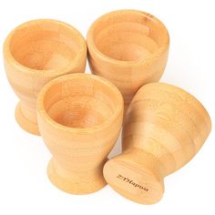 three wooden cups are sitting next to each other