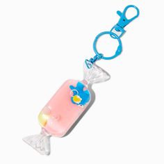 a plastic keychain with a bottle shaped like a fish on it's side