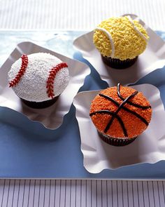 three cupcakes decorated with sports balls and sprinkles