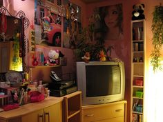 a television sitting on top of a wooden dresser