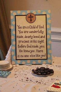 a table topped with blueberries and a sign that says you are a child of god