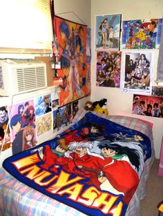 a bed room with a neatly made bed and pictures on the wall