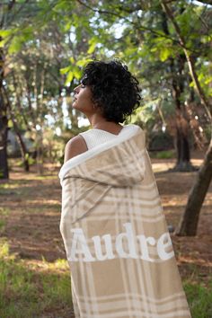 a woman wrapped in a blanket with the word audre printed on it