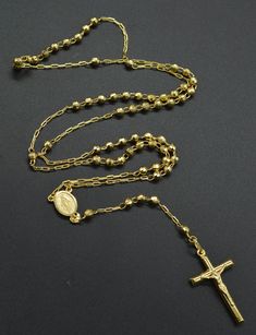 10k solid yellow gold rosary Virgin Mary Jesus cross necklace 18'' 9.3 gr is perfect for your loved one and they will be happy for the rest of their life. Comfortable and practical to wear every day. PRODUCT INFORMATION: Total weight 9.2 Grams Upper beaded chain 18 inches long all around From the top of Virgin Mary pendant to the bottom of the cross 4.5 inches long Cross 1.1/4'' long Cross width 20 mm Beads 4 mm width Virgin Mary oval pendant 11 mm long Stamped. 10k Comes with a beautiful gift b Yellow Gold Rosary With Miraculous Medal As Gift, Yellow Gold Cross Rosary As Gift, Mens Bracelet Gold Jewelry, Jesus Cross Necklace, 10k Gold Chain, Gold Rosary, Jesus Cross, Mens Gold Bracelets, Jewelry Chain