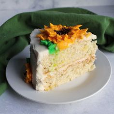 a piece of cake with sunflowers on top is sitting on a white plate