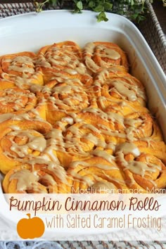 pumpkin cinnamon rolls with salted caramel frosting in a casserole dish