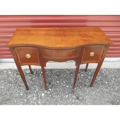 an antique wooden desk with two drawers