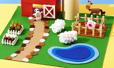 a paper model of a farm scene with animals