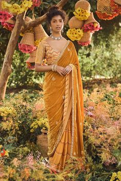 Mustard yellow saree with bandhani prints, gota and marodi work buttis with velvet palla. Paired with hand embroidered blouse.
Component: 2
Printed, Embroidered
Neckline: Scoop
Sleeve Length: Elbow
Fabric: Satin Silk, Velvet
Color: Yellow
Bandhani prints
Gota and marodi work
Velvet palla
Back V-neck with tassel tie-up - Aza Fashions Marodi Work, Punit Balana, Velvet Saree, Hand Embroidered Blouse, Native Dress, Modern Saree, Yellow Saree, Yellow Satin, Saree Trends