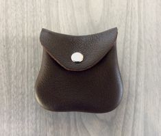 a brown leather pouch sitting on top of a wooden table