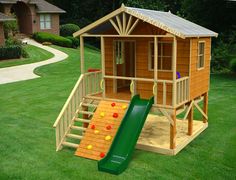 a small wooden play house with a slide