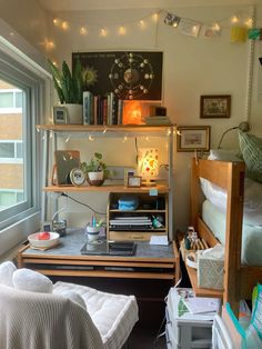 a bedroom with a bed, desk and shelves full of books on it's sides