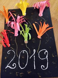 a black board with flowers and the year 2019 written on it