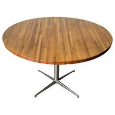 a round wooden table with metal legs on an isolated white background for use as a centerpiece