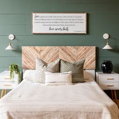 a bedroom with green walls and white bedding has a wooden headboard that says, be your guest