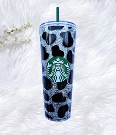 the starbucks cup is decorated with black and white spots