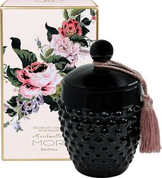 a black vase with flowers on it next to a box and a pink flower design