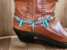 Turquoise blue & silver southwestern tribal gemstone boot bracelet, Cowboy boot jewelry, Western boot chain.  This bracelet is made with faux turquoise resin spike beads paired with a turquoise Imperial jasper gemstone centerpiece.  Turquoise magnesite coin beads frame southwestern style stamped beads. Small silver lantern spacer beads, and tiny silver spacer beads complete the strand.  The chain is a sturdy stainless steel curb chain that is approximately 16 inches long.  It's adjustable to fit most boots.  The closure is a lobster claw clasp.  This piece is ready to ship!  **Listing for a single bracelet**   Thank you for visiting my shop!   Every order ships beautifully packaged.  Special gift packaging with matching gift/note cards are available.  Please contact me with your gift messa Silver Lanterns, Southwestern Blue Hand-strung Bracelet, Southwestern Style Hand-strung Blue Bracelet, Southwestern Style Blue Hand-strung Beads, Turquoise Resin, Boot Chains, Jewelry Western, Boot Bracelet, Southwestern Silver Turquoise Multi-stone Necklace