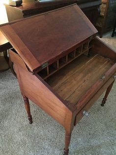 an old wooden desk with drawers on it