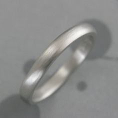 Platinum 3mm Wide Comfort Fit Band Platinum Wedding Ring Handmade Platinum Wedding Ring Rounded Exterior and Interior Ring Made Just for YOU Our simple 3mm wide by 2mm thick rounded comfort fit design in elevated in solid platinum! If you are looking for a simple, comfortable modern ring that will last through many lifetimes, this is the band for you! Hand forged in our studio to size just for you, your ring can either be high polished or brushed. We also offer engraving services for a personalized touch. Platinum is one of the most difficult metals to work in. I have put my 20+ years of experience into branching out into platinum designs. It's by far the most durable of metals and my own wedding set is platinum. We use 950 Platinum/Ruthenium. The Ruthenium alloy is the best alloy for fabr Wedding Ring With Smooth Finish And Round Band, Wedding Band With Smooth Finish, Wedding Rings With Smooth Finish And Round Band, Wedding Rings With Smooth Finish, Wedding Rings With Thick Band And Smooth Finish, Silver Wedding Rings With Brushed Finish, Elegant Wedding Rings With Brushed Finish, Simple Polished Stackable Wedding Rings, Minimalist Wedding Bands With Smooth Finish