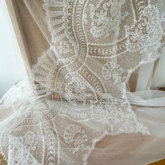 an image of white lace on sheer fabric