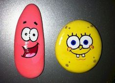 two spongebob magnets sitting next to each other on top of a table