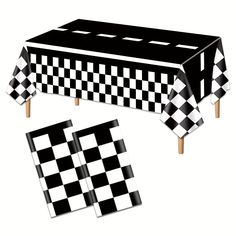 a black and white checkered tablecloth with matching place mats for the table top