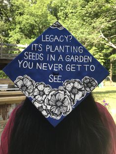 a blue graduation cap that says, legacy it's planting seeds in a garden you never get to see