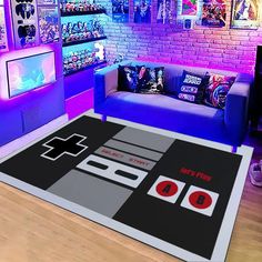 a living room filled with furniture and a nintendo game controller on the rug in front of a tv